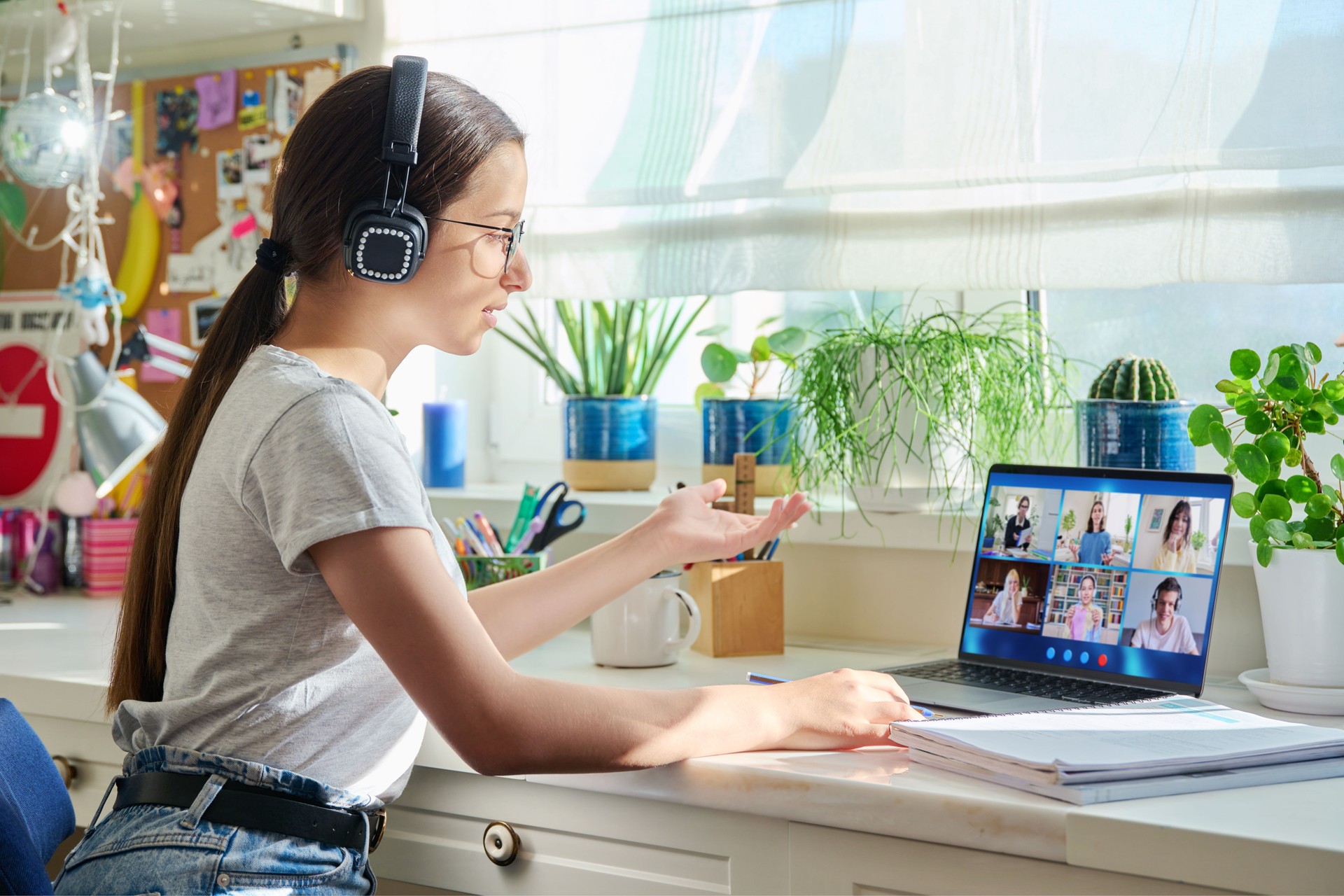 Video conference, teen girl looking at computer screen with group of students